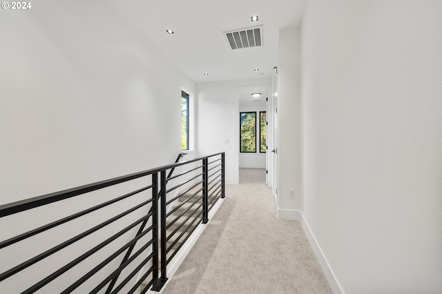 corridor with light colored carpet