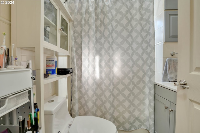 bathroom featuring toilet and large vanity