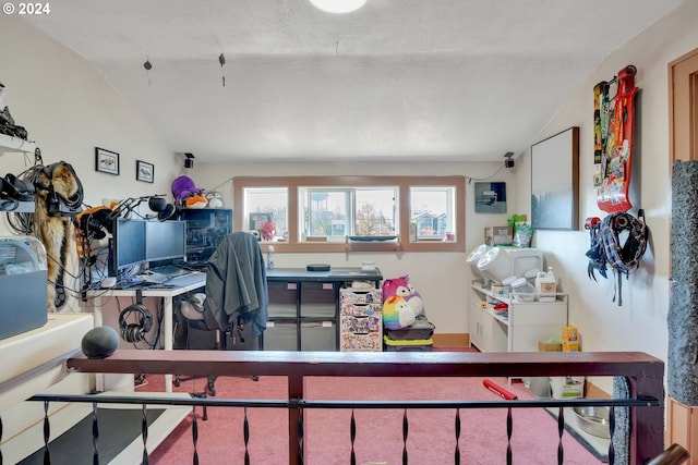 office space with lofted ceiling and a textured ceiling