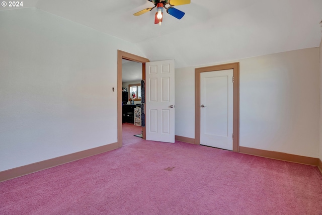 empty room featuring ceiling fan, light colored carpet, and vaulted ceiling