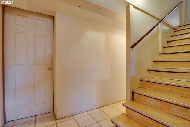 staircase with light tile floors