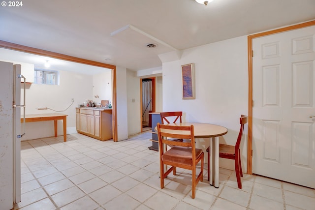 dining space featuring light tile floors