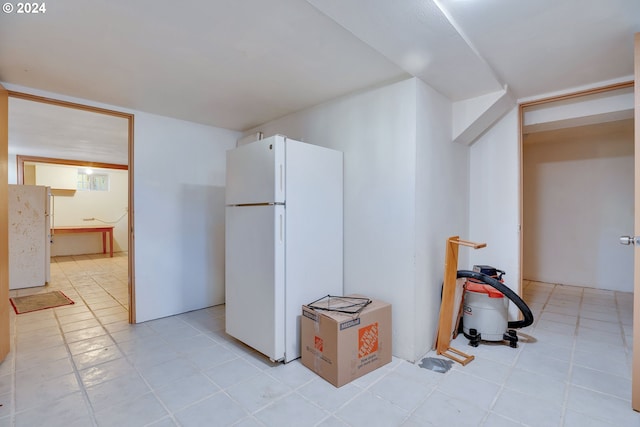 interior space featuring white refrigerator and light tile flooring