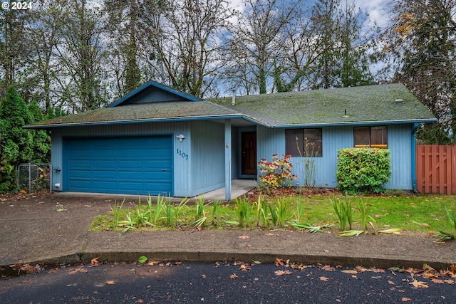 ranch-style home featuring a garage