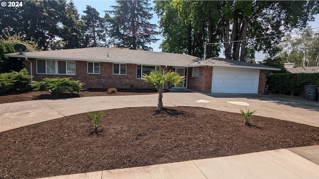 ranch-style home with brick siding, an attached garage, and concrete driveway