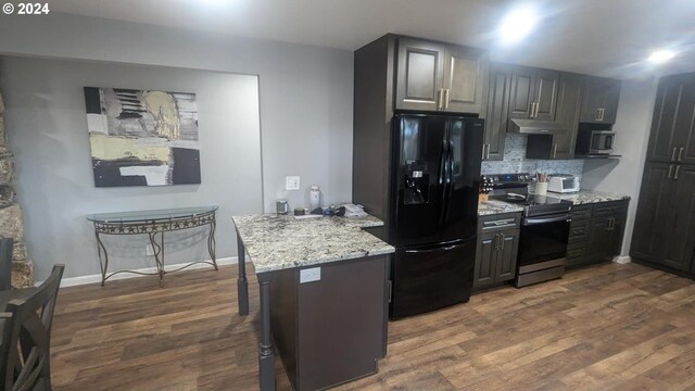 kitchen with light stone countertops, stainless steel appliances, dark hardwood / wood-style floors, and tasteful backsplash