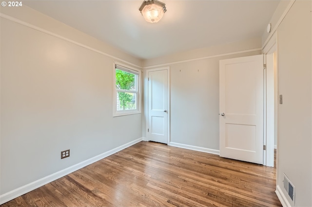 unfurnished bedroom featuring hardwood / wood-style flooring