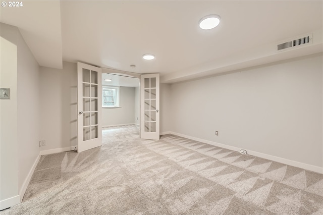 basement featuring carpet and french doors