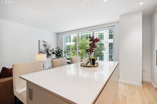 dining area featuring recessed lighting, light wood-type flooring, and baseboards