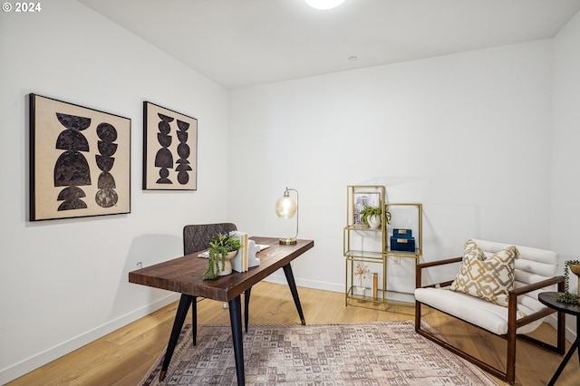 office space featuring baseboards and light wood-style floors