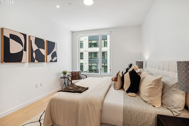 bedroom with recessed lighting, baseboards, and wood finished floors