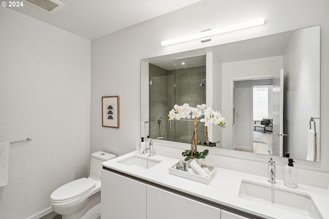 bathroom with visible vents, a shower stall, toilet, and a sink