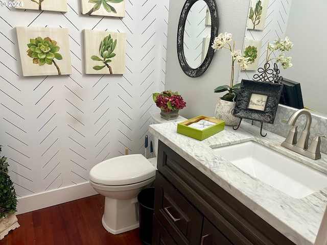 bathroom with vanity, toilet, and wood-type flooring