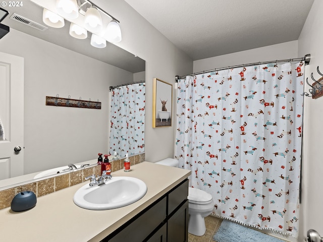 bathroom featuring a shower with curtain, tile patterned floors, a textured ceiling, toilet, and vanity