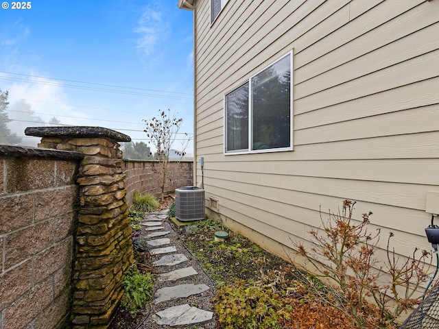 view of side of property with central air condition unit