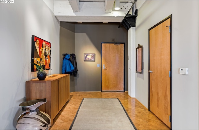 corridor with light hardwood / wood-style flooring and a towering ceiling