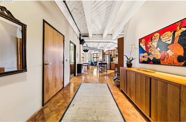 hall with wood ceiling and lofted ceiling with beams