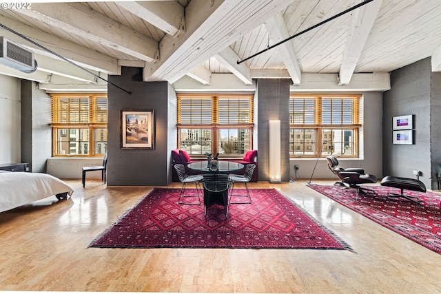 interior space with wood-type flooring, beamed ceiling, and plenty of natural light