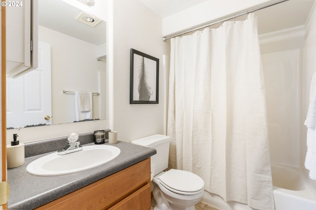 full bath with shower / bath combo, vanity, and toilet