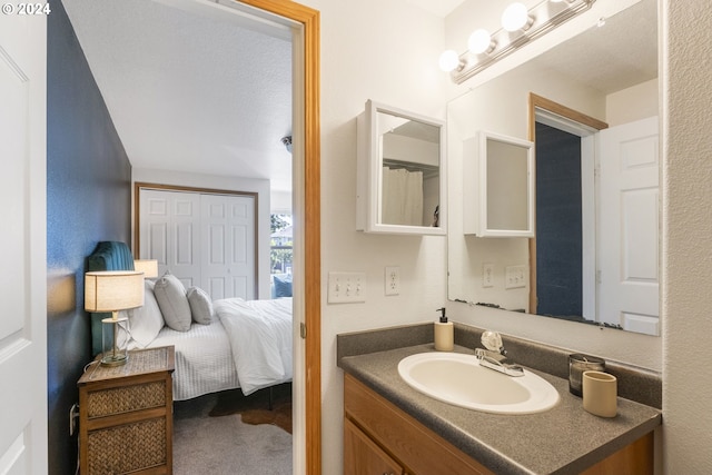 ensuite bathroom featuring ensuite bathroom and vanity