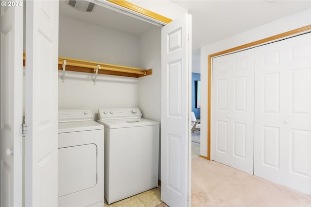 washroom with light colored carpet and washing machine and clothes dryer