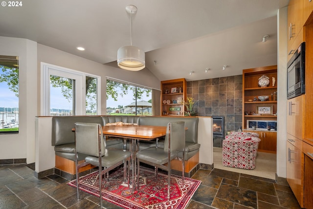 dining room featuring tile walls and a tile fireplace