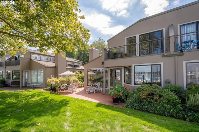 rear view of property with a patio area and a yard