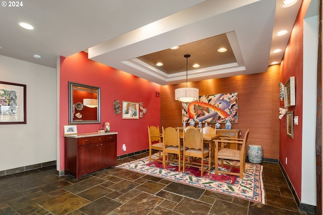 dining area with a tray ceiling