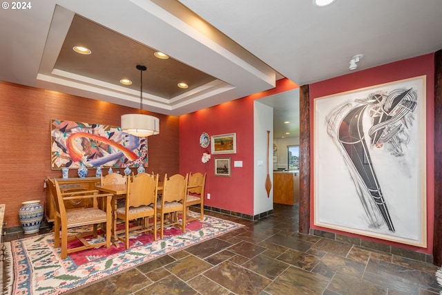 dining room with a raised ceiling