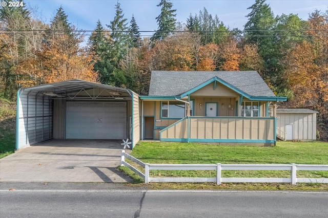 view of front of house with a carport, a porch, a front lawn, a garage, and an outdoor structure