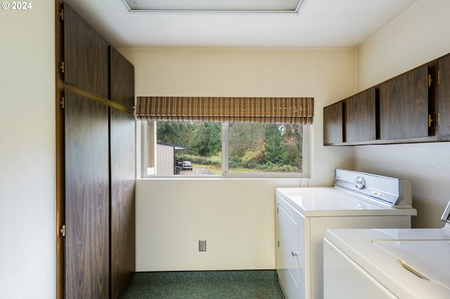 laundry room featuring cabinets, dark colored carpet, and separate washer and dryer