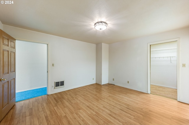 unfurnished room with light wood-type flooring