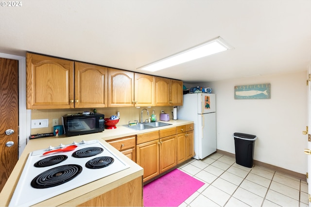 kitchen with white appliances, sink, and light tile patterned floors