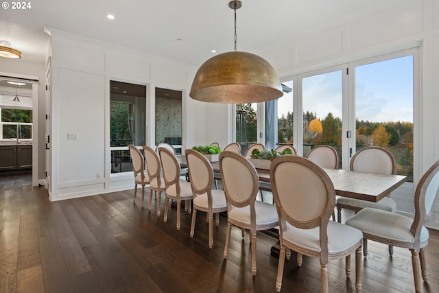 dining space with a wealth of natural light and dark hardwood / wood-style floors