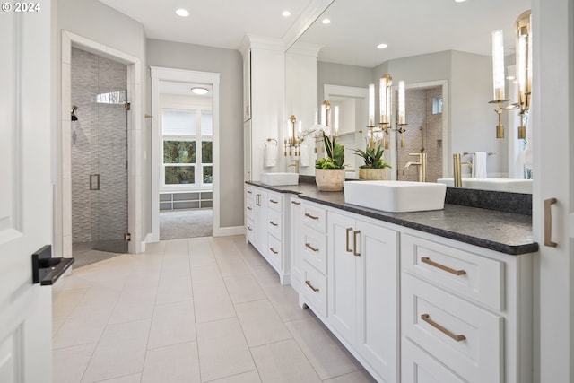 bathroom with tile patterned floors, vanity, and a shower with shower door