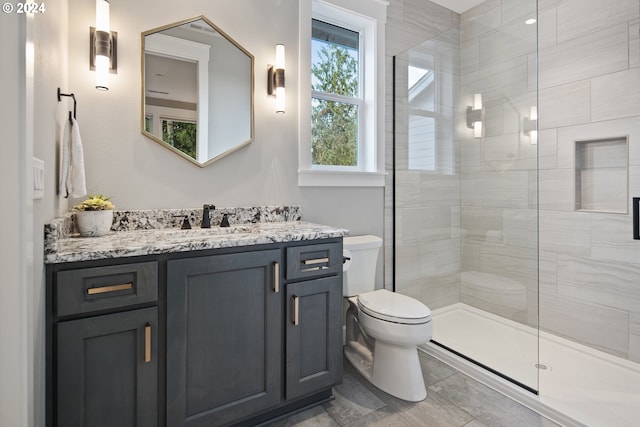 bathroom featuring vanity, toilet, and walk in shower