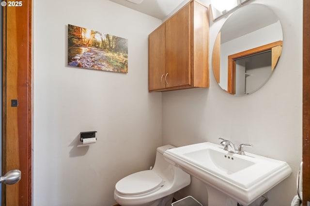 bathroom featuring toilet and a sink