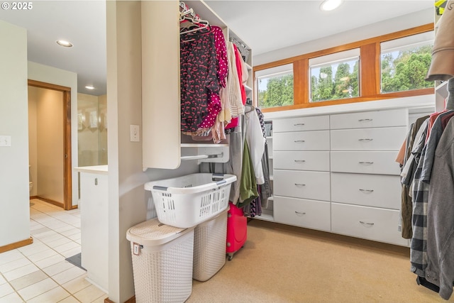 walk in closet with light tile patterned floors