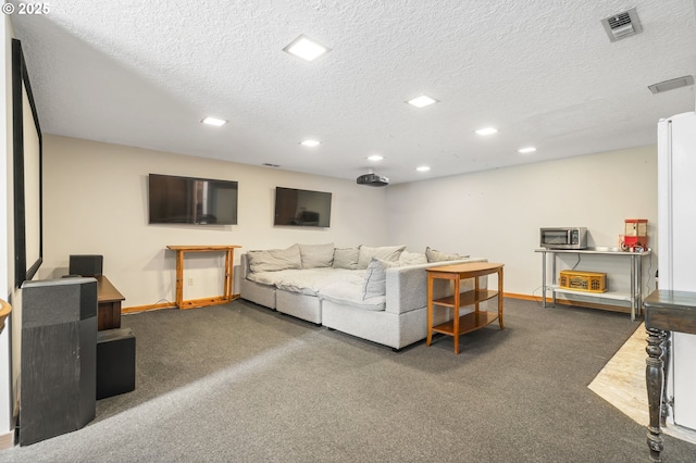 carpeted living area with recessed lighting, baseboards, visible vents, and a textured ceiling