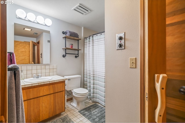 bathroom with visible vents, toilet, tile patterned flooring, decorative backsplash, and vanity