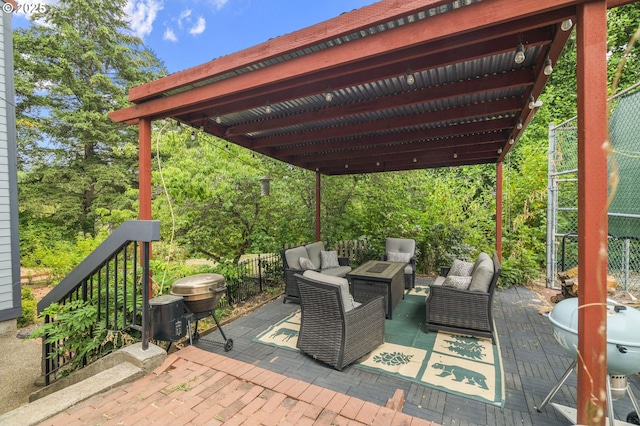 view of patio featuring a grill, outdoor lounge area, and fence