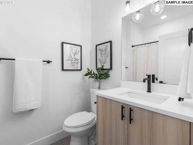 bathroom with tile patterned floors, vanity, and toilet