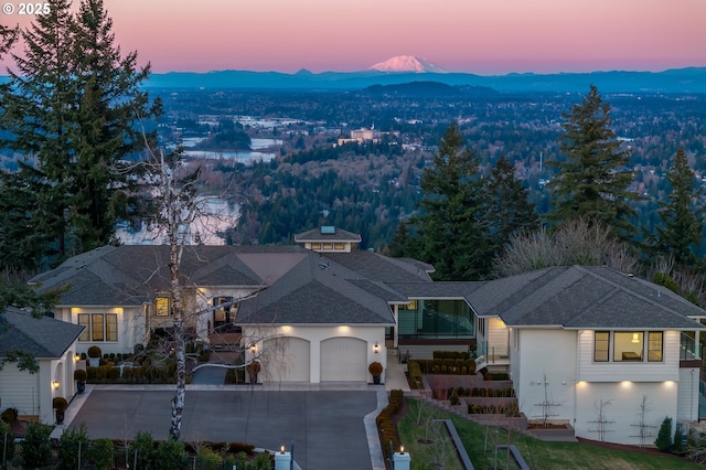 aerial view at dusk featuring a mountain view