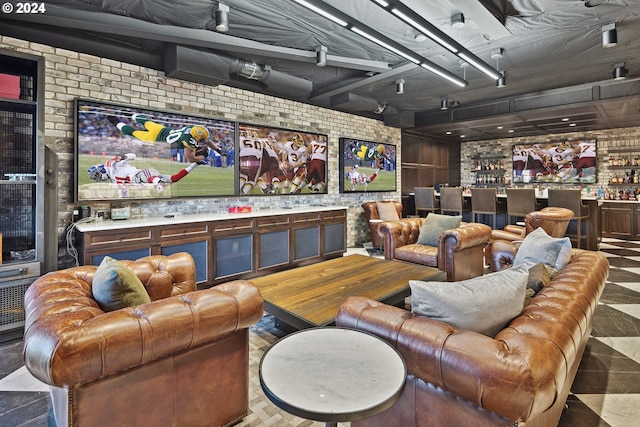 cinema room featuring brick wall and bar area