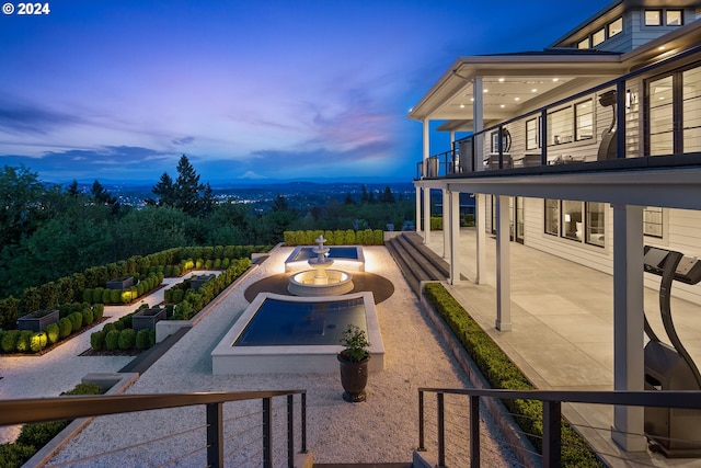 patio terrace at dusk with a balcony