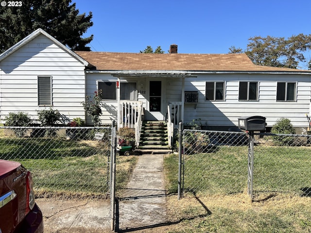 bungalow-style house featuring a front lawn