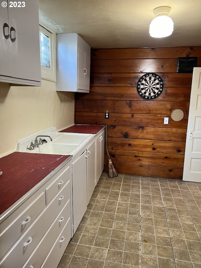 clothes washing area featuring wood walls