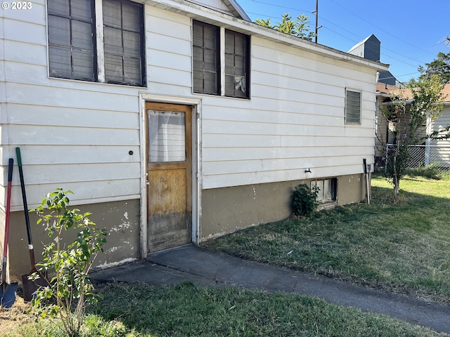 entrance to property with a yard