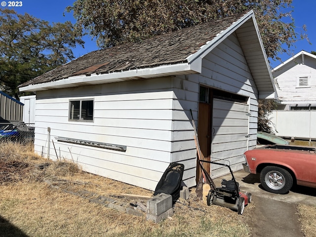 view of home's exterior with a garage and an outdoor structure