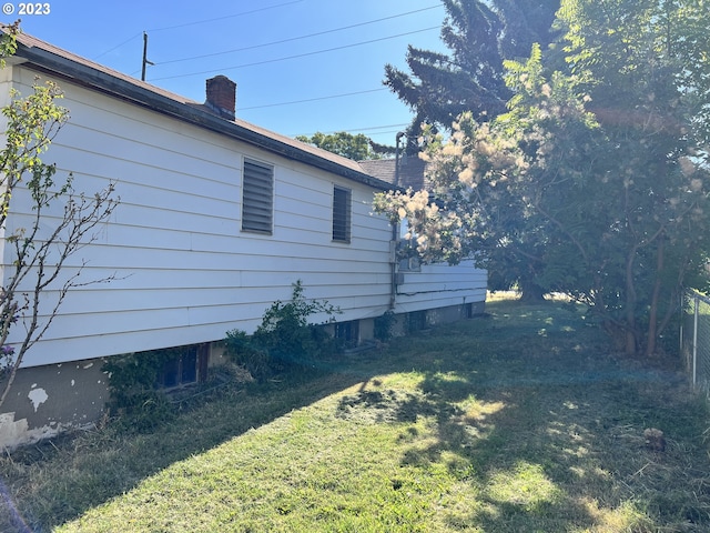 view of property exterior featuring a lawn